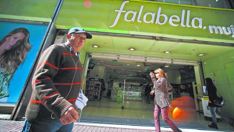 People walk past a Falabella department store in downtown Santiago