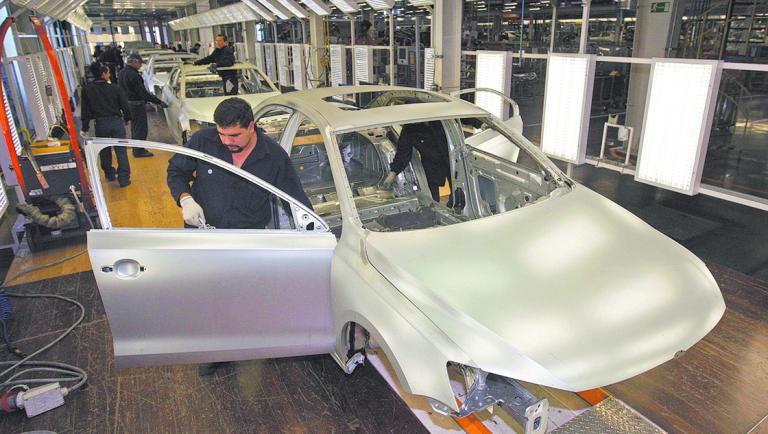 Employees work on the assembly line on the Jetta Bicentennial at the Volkswagen automobile manufacturing factory in Puebla