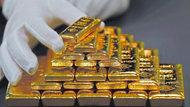 FILE PHOTO: An employee sorts gold bars in the Austrian Gold and Silver Separating Plant 