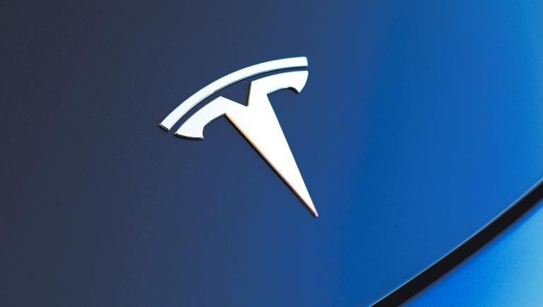 FILE PHOTO: The front hood logo on a 2018 Tesla Model 3 electric vehicle is shown in Cardiff, California