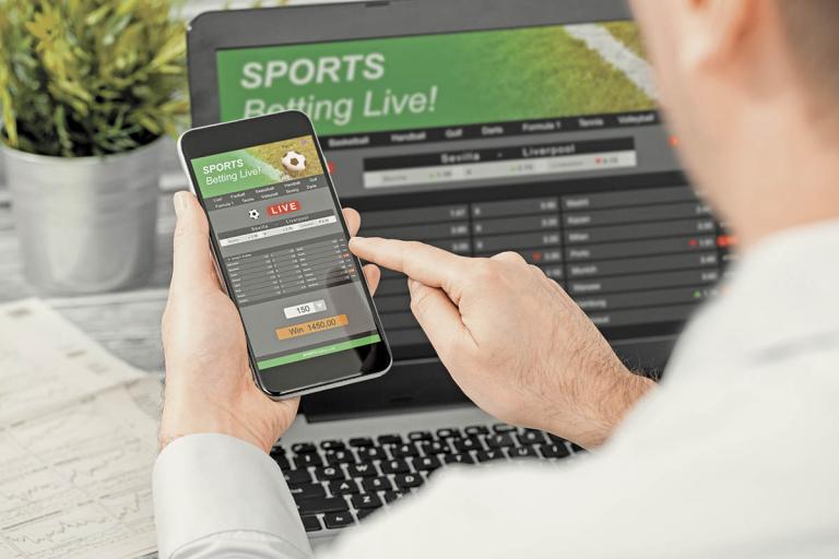 Betting,Bet,Sport,Phone,Gamble,Laptop,Over,Shoulder,Soccer,Live