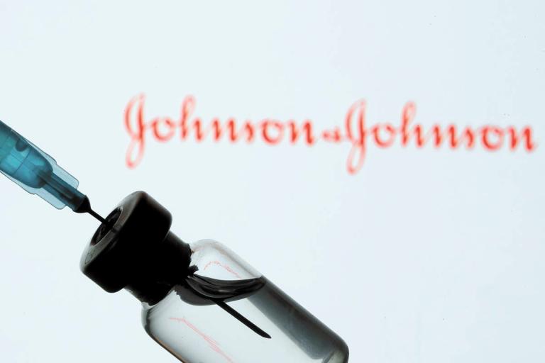 FILE PHOTO: A vial and sryinge are seen in front of a displayed Johnson&Johnson logo in this illustration taken January 11, 2021. REUTERS/Dado Ruvic/Illustration/File Photo-NARCH/NARCH30