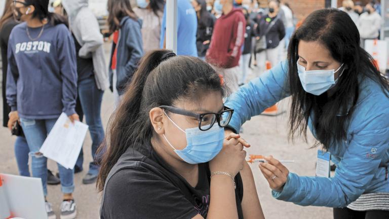 Residents line up for a COVID-19 vaccine clinic in Chelsea