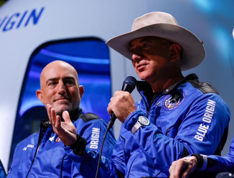 FILE PHOTO: Billionaire American businessman Jeff Bezos speaks with his brother Mark at a post-launch press conference, in the nearby town of Van Horn