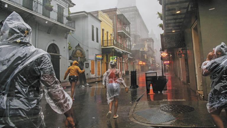 NEW ORLEANS, LOUISIANA - AUGUST 29: A group of people walk through the French District during Hurricane Ida on August 29, 2021 in New Orleans, Louisiana. Hurricane Ida made landfall earlier today and continues to cut across Louisiana. Hurricane Ida has been classified as a Category 4 storm with winds of 150 mph.   Brandon Bell/Getty Images/AFP== FOR NEWSPAPERS, INTERNET, TELCOS & TELEVISION USE ONLY ==-== FOR NEWSPAPERS, INTERNET, TELCOS & TELEVISION USE ONLY ==