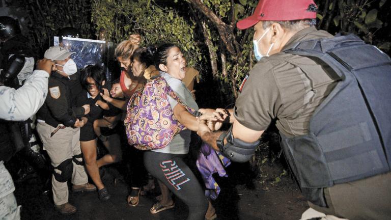 Agents of the National Migration Institute and National Guard detain migrants from Central America and the Caribbean, in Huixtla