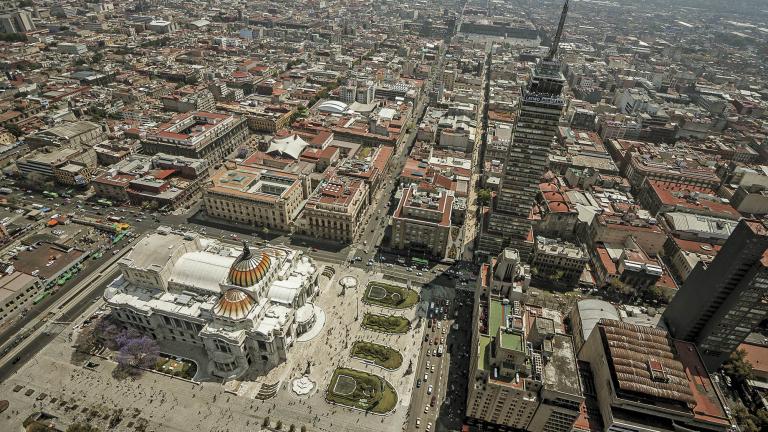 Aerial view of Mexico City center over palace of beautiful arts and latin american tower, with main square in the back