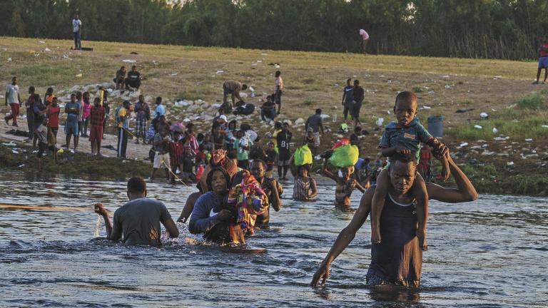 Haitian migrants continue to cross across the US-Mexico border on the Rio Grande as seen from Ciudad Acuna, Coahuila state, Mexico on September 20, 2021. - Migrant families sent back to Haiti by the United States after attempting to enter the country from Mexico are angry at their treatment and fearful of returning back home to a life punctuated by gang violence. The deportation of Haitian migrants had been temporarily suspended by Washington after a devastating earthquake hit the Caribbean nation last month.But in recent days, more than 15,000 Haitians crossed into the country from Mexico and found themselves stranded for days in Texas under a bridge spanning the Rio Grande river, blocked from moving onwards. (Photo by PAUL RATJE / AFP)