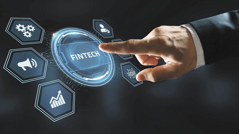 Fintech -financial technology concept.Young businessman  select the icon Fintech on the virtual display.