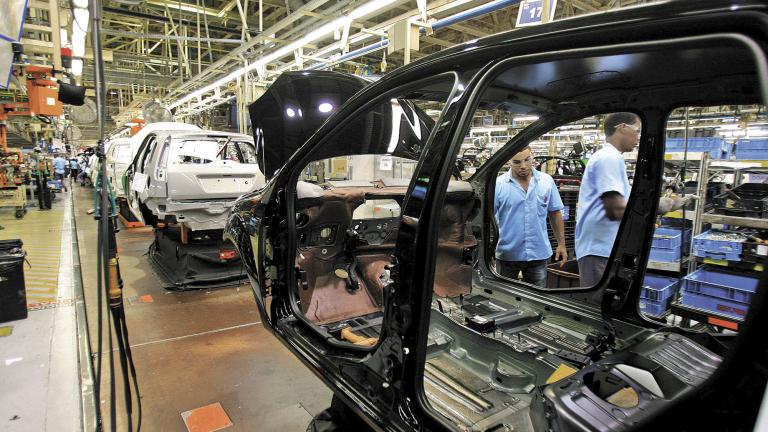 camacari, bahia / brazil - december 12, 2013: workers are seen on the assembly line at the Ford factory in the Industrial Pole of the city of Camacari.