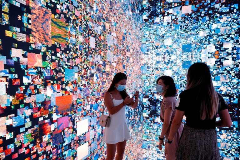 FILE PHOTO: Visitors are pictured in front of an art installation which will be converted into NFT and auctioned online at Sotheby