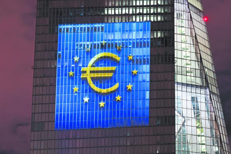 A symphony of light consisting of bars, lines and circles in blue and yellow, the colours of the European Union, illuminates the south facade of the European Central Bank (ECB) headquarters in Frankfurt, Germany, December 30, 2021.   REUTERS/Wolfgang Rattay