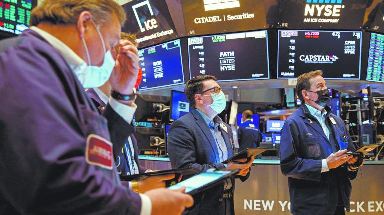 Traders work on the floor of the NYSE in New York