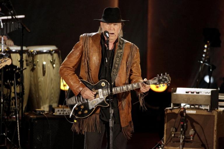 FILE PHOTO: Singer/songwriter Neil Young performs during a concert honoring singer/songwriter Willie Nelson, recipient of the Library of Congress