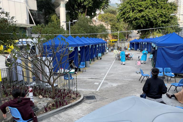 Medical workers wearing protective masks and face shields monitor an area outside a hospital, following the coronavirus disease (COVID-19) outbreak in Hong Kong