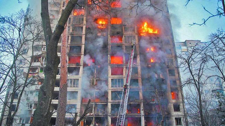 Rescuers work next to a residential building damaged by shelling in Kyiv