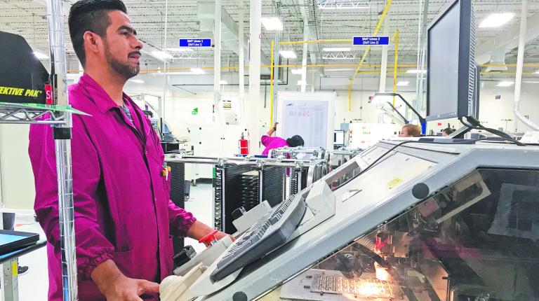 A worker checks his monitor at Firstronica€™s Juarez plant assemble electronic parts for cars built by GM Audi and Hyundai among others in Ciudad Juarez