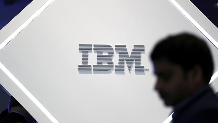 FILE PHOTO: A man stands near an IBM logo at the Mobile World Congress in Barcelona, Spain, February 25, 2019. REUTERS/Sergio Perez/File Photo  GLOBAL BUSINESS WEEK AHEAD-NARCH/NARCH30