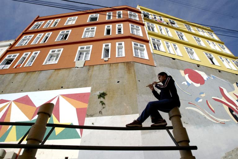 FILE PHOTO: A girl plays the flute at the Bellavista hill in Valparaiso June 15, 2003