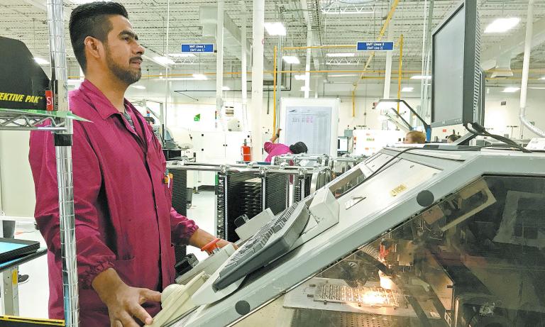 A worker checks his monitor at Firstronica€™s Juarez plant assemble electronic parts for cars built by GM Audi and Hyundai among others in Ciudad Juarez