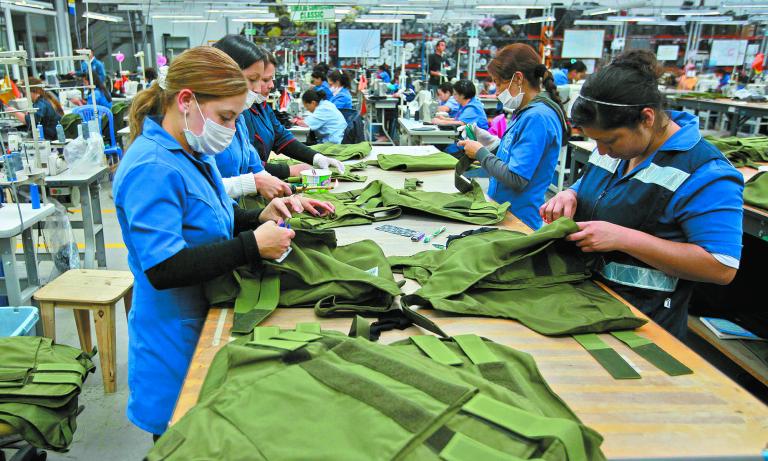 Workers put the finishing touches to bulletproof vests and other armoured clothing at the Miguel Caballero factory on the outskirts of Bogota