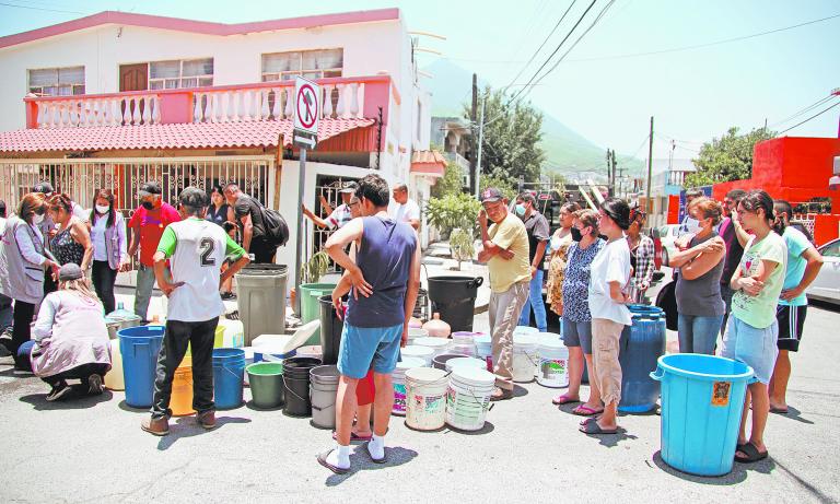 Residents wait for the water truck to arrive at La Hacienda neighborhood in Guadalupe