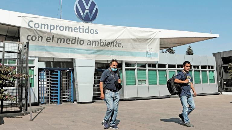 Employees leave the Volkswagen (VW) plant as the company will temporarily close its factories in Mexico amid growing worries over the spread of the coronavirus disease (COVID-19), in Puebla, Mexico March 29, 2020. REUTERS/Imelda Medina