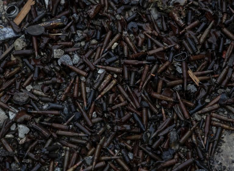 Cartridges are seen near a destroyed Russian Armoured Personnel Carrier (APC) is seen near the village of Nova Husarivka