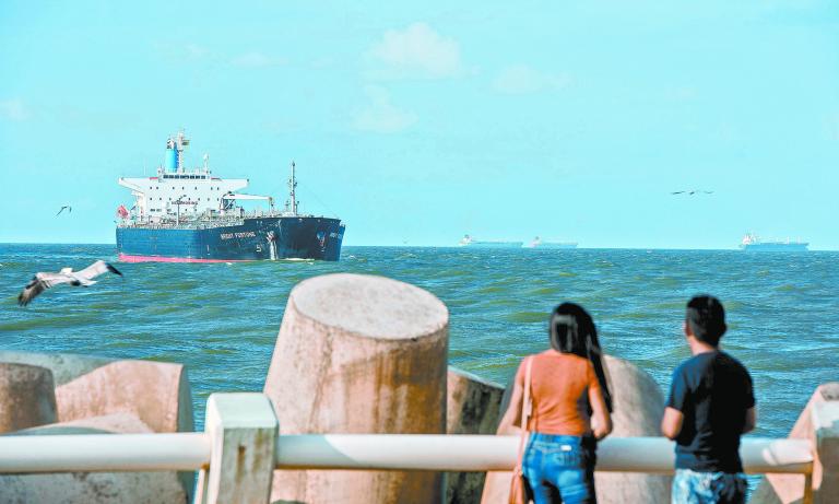 People look at a Bright Fortune crude oil tanker floating near Pemex