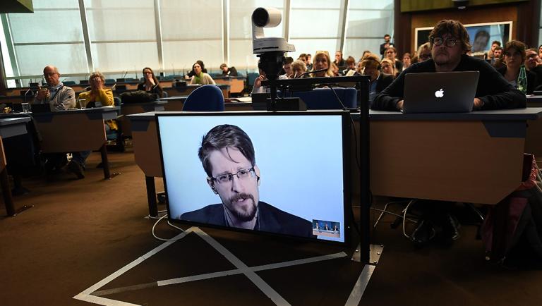 (FILES) In this file photo taken on March 15, 2019 former US National Security Agency (NSA) contractor and whistle blower Edward Snowden speaks via video link from Russia as he takes part in a round table meeting on the subject of