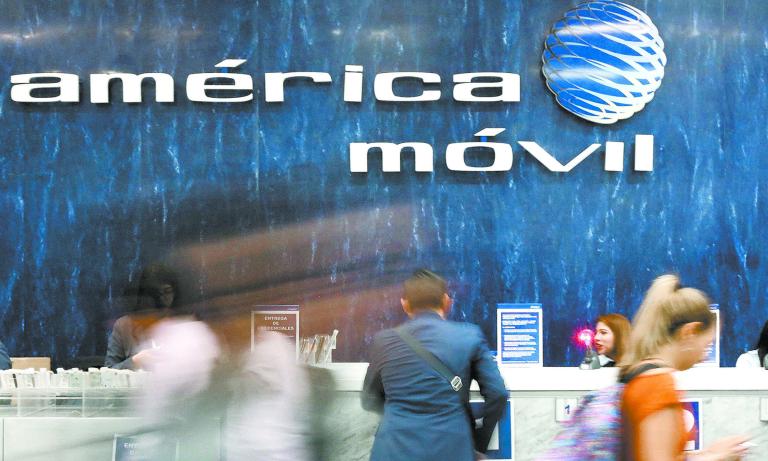 FILE PHOTO: The logo of America Movil is pictured on the wall of a reception area in the company's corporate offices in Mexico City, Mexico, May 18, 2017. REUTERS/Edgard Garrido/File Photo-NARCH/NARCH30