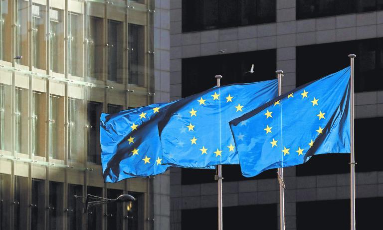 FILE PHOTO: European Union flags fly outside the European Commission headquarters in Brussels