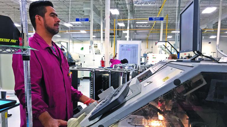 A worker at Grand Rapids, Michigan-based Firstronica€™s plant in Ciudad Juarez, Mexico checks his monitor in Ciudad Juarez, Mexico on October 2, 2017. Picture taken on October 2, 2017.    REUTERS/Ann Saphir