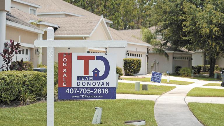 FILE PHOTO: For Sale signs stand in front of houses in a neighborhood where many British people have purchased homes in Davenport, Florida, U.S., June 29, 2016.  Photo taken June 29, 2016. REUTERS/Phelan Ebenhack/File Photo-NARCH/NARCH30