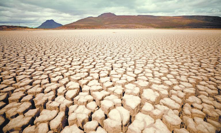 FILE PHOTO: Clouds gather but produce no rain as cracks are seen in the dried up municipal dam in drought-stricken Graaff-Reinet