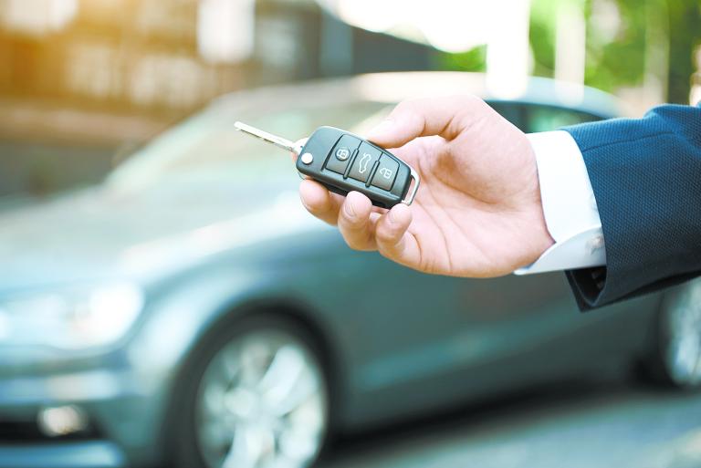 Dreams Come True. Young man holds the keys to a new car