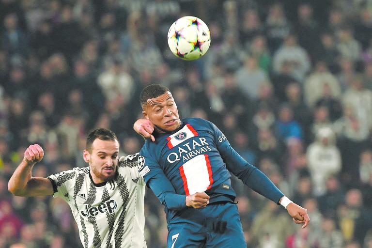 Paris Saint-Germain's French forward Kylian Mbappe heads the ball during the UEFA Champions League 1st round day 6 group H football match between Juventus Turin and Paris Saint-Germain (PSG) at the Juventus stadium in Turin on November 2, 2022. (Photo by Filippo MONTEFORTE / AFP)