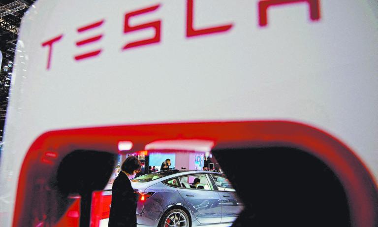 FILE PHOTO: A Tesla electric vehicle is seen through a charging point displayed during a media day for the Auto Shanghai show in Shanghai, China April 20, 2021. REUTERS/Aly Song/File Photo/File Photo-NARCH/NARCH30 NARCH/NARCH30 NARCH/NARCH30 NARCH/NARCH30