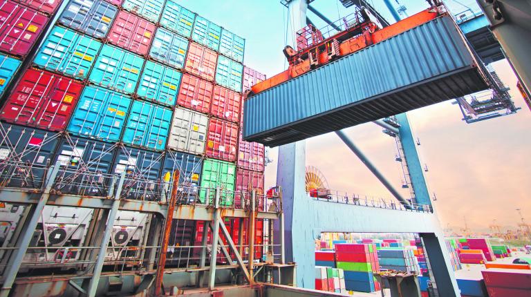 Container loading in a Cargo freight ship with industrial crane. Container ship in import and export business logistic company. Industry and Transportation concept.