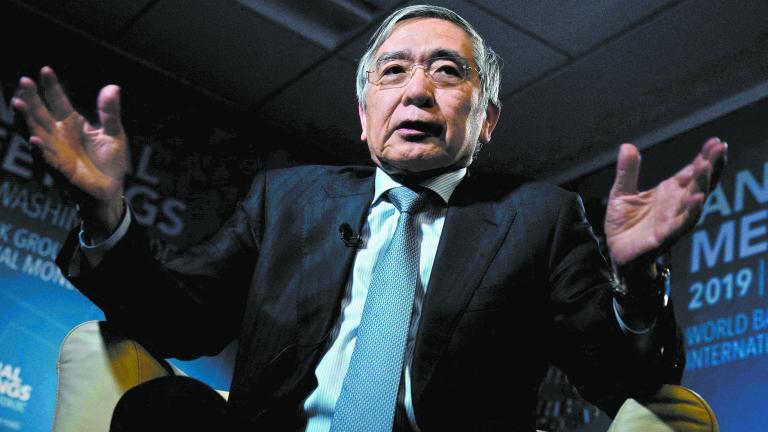 FILE PHOTO: Bank of Japan (BOJ) Governor Haruhiko Kuroda, gestures as he replies a question during an interview with Reuters in Washington