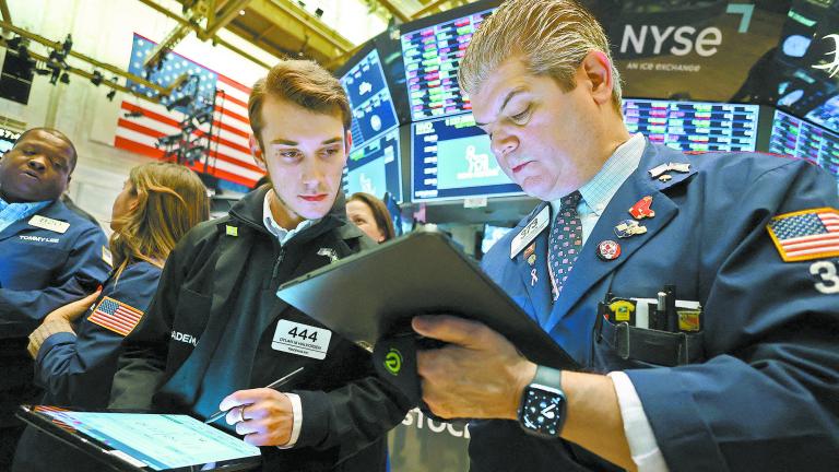 Traders work on the trading floor at the New York Stock Exchange (NYSE) in New York City, U.S., January 27, 2023. REUTERS/Andrew Kelly