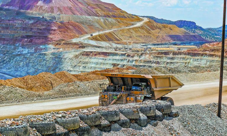 Silver City, New Mexico USA - July 30, 2019: Ore hauling truck in the Santa Rita Chino copper mine carrying hundreds of tons of raw material from the open pit excavation.