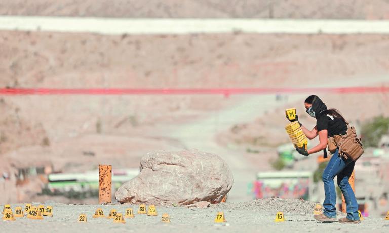 A forensic technician works at a crime scene where unknown assailants murdered a ministerial police officer and his wife, according to local media, in Ciudad Juarez, Mexico April 17, 2022. REUTERS/Jose Luis Gonzalez