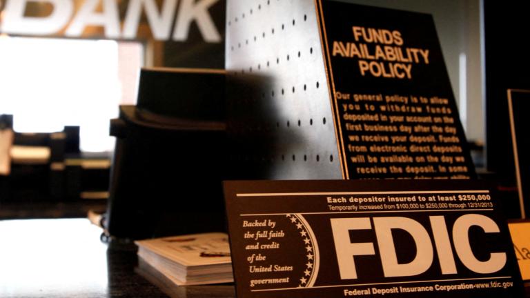 FILE PHOTO: Signs explaining Federal Deposit Insurance Corporation (FDIC) and other banking policies are shown on the counter of a bank in Westminster