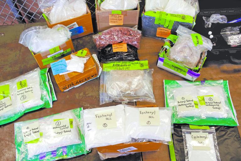 FILE PHOTO: Plastic bags of fentanyl are displayed on a table at the U.S. Customs and Border Protection area at the International Mail Facility at O'Hare International Airport in Chicago, Illinois, U.S. November 29, 2017.  REUTERS/Joshua Lott/File Photo-NARCH/NARCH30