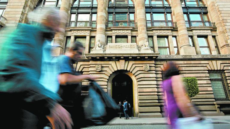 FILE PHOTO: People walk past the building of Mexico