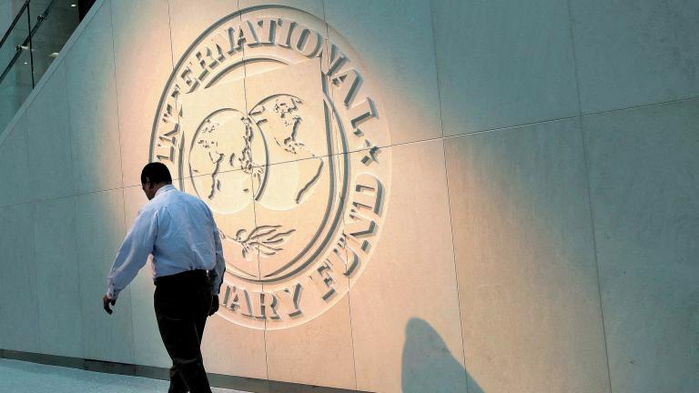 FILE PHOTO: A man walks past the International Monetary Fund (IMF) logo at its headquarters in Washington, U.S., May 10, 2018. REUTERS/Yuri Gripas/File Photo-NARCH/NARCH30 NARCH/NARCH30 NARCH/NARCH30 NARCH/NARCH30