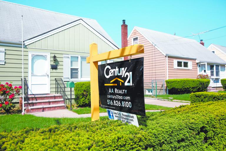 A 'for sale' is seen outside a single family house in Uniondale, New York, U.S., May 23, 2016.  REUTERS/Shannon Stapleton