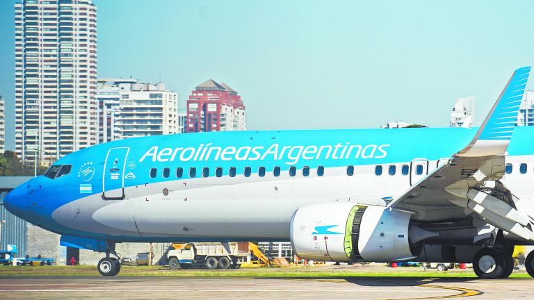 An Aerolineas Argentinas airplane taxis along the runway at the Jorge Newbery Airport in Buenos Aires, on August 2, 2017.Argentine state-run carrier Aerolineas Argentinas cancelled its August 5 weekly flight to Caracas over operational capacity and security concerns, the company said. Several foreign airlines, including Air France, Delta, Avianca and Iberia have also suspended flights to the country over security concerns due to the political situation. / AFP PHOTO / Eitan ABRAMOVICH