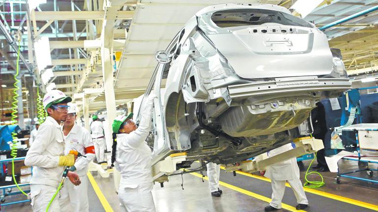 Employees work at a production line after the opening of Honda